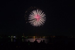 fireworks exploding over lake