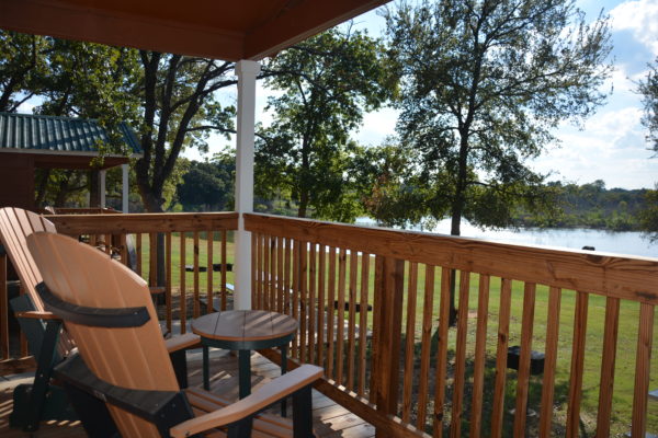 view of lake and trees from front porch of cabin