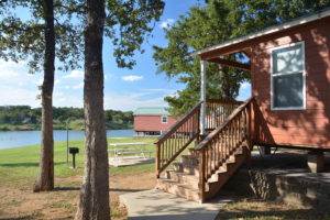 Cabin exterior with lake view and trees